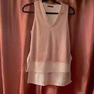 One piece V neck with no sleeve tank blouse. Size Small.